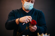 © Cavan Images - Happy caucasian florist making selling red roses for valentine day