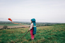 Young Girl Flying A Kite In The English Countryside In Winter