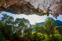 Man Climbing On Overhanging Limestone Cliff In Laos