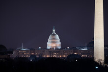 The US Capitol Building And The Washington Monument At Night.