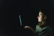 © Cavan Images - woman working on laptop at night