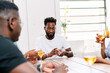 © PICHA - Friends playing cards while enjoying wine at home