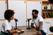 © PICHA - A Black Woman interviewing a guest for a podcast