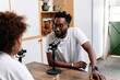 © PICHA - A Black Woman interviewing a guest for a podcast