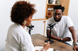 © PICHA - A Black Woman interviewing a guest for a podcast