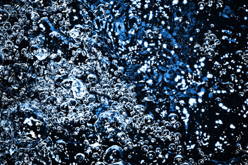 Wall Mural - Boiling water bubbles. Air bubble background. Fizzy water texture. Black water pattern. Dark wet background.