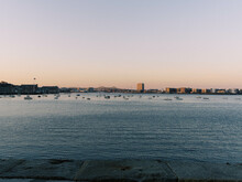 Sunset Skyline View From Boston Harbor In Massachusetts