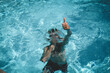 © Cavan Images - Boy Gives a Thumbs up While Holding Breath Underwater