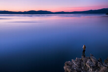 Young Female Overlooking Lake Tahoe At Sunset