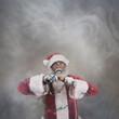 © soupstock - Santa Claus plugging in Christmas lights looking shocked surrounded by smoke
