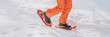 © Maridav - Snowshoes. Snowshoeing man in winter forest mountain in snow. People on hike in snow hiking in snowshoes living healthy active outdoor lifestyle in winter on snowy day. Legs and snowshoe closeup