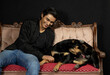 © Carlos - boy laughing in amusement because his dog is licking his privates