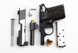 © Atlantist studio - Parts of .380 semi automatic pistol handgun with bullets on white background , Gun disassembled