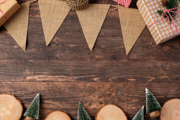 Poster - Christmas wood log plate and kraft flag and xmas tree on brown wooden table