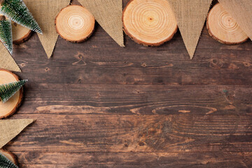 Poster - Christmas wood log plate and kraft flag and xmas tree on brown wooden table