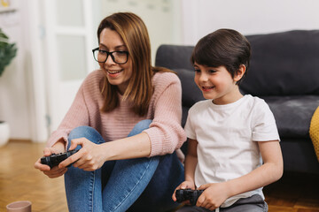 Wall Mural - mother and son playing video games at home