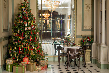 Wall Mural - Christmas morning interior with christmas tree Vintage chandelier. White, red and gold balls on the Christmas tree.