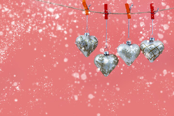 Wall Mural - Christmas balls hearts on a pink background.