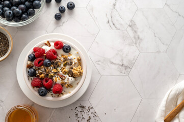 Wall Mural - Bowl of muesli, granolla or oats with fresh berries, breakfast food. Copy space.