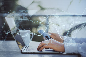 Aufkleber - Close up of businessperson hands using laptop and smartphone with creative glowing business chart and map hologram on blurry background. Business data and market concept. Double exposure.