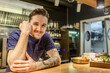 © Westend61 - Smiling male bartender standing while leaning on bar counter