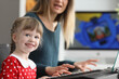 © H_Ko - Pretty happy kid learns how to play on piano with mother