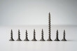 A row of similar screws and a different one