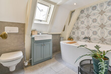 Interior Of Cozy Bathroom With Ornamental Walls And Bathtub