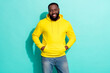 © deagreez - photo of charismatic positive guy hold hands pockets jeans denim isolated over cyan color background
