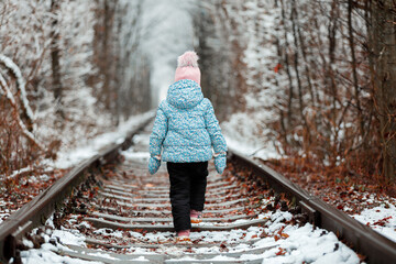 Wall Mural - girl in railway snow tunnel. love tunnel in winter.