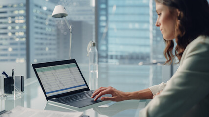 Poster - Young Successful Businesswoman Sitting at Desk Working on Laptop Computer in City Office. Talented Top Manager Doing Data Analysis, Growth Statistics for e-Commerce Project. Over Shoulder Shot