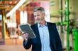 © Westend61 - Male professional using digital tablet while standing at power station