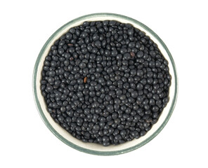 Wall Mural - black lentils in a bowl isolated on white background