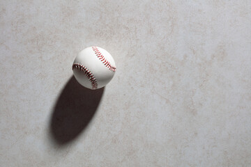 Wall Mural - Baseball ball on dark gray textured background with copy space.