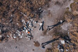 the corpse of a murdered teenage girl is examined by an expert found using a drone in a garbage dump during aerial photography to search for missing people, forensic examination