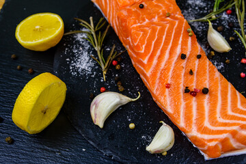 Wall Mural - Raw fillet of salmon fish and spices on a slate board