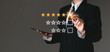 © Dee karen - Businessman touching virtual screen on satisfaction rating icon in customer service and satisfaction concept. to give a good rating on the service That rating is a star icon.