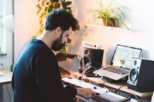 Male Music Composer Using Piano In Studio