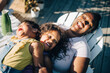 © Maskot - High angle view of daughters and mother in backyard