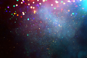 background of abstract glitter lights. gold, blue and black. de focused