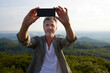 © Westend61 - Man taking selfie through smart phone