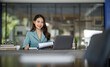 © David - Shot of a asian young business Female working on laptop computer in her workstation.Portrait of Business people employee freelance online marketing e-commerce telemarketing concept.