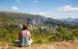 © Westend61 - Greece, Epirus, Zagori, Female hiker admiring forest surrounding village inVikos-AoosNational Park during summer