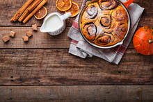 Cinnabon Cinnamon Rolls Buns With Pumpkin, Nut, Caramel And Sugar Cream Iced On Rustic Wooden Background Table. Top View. Sweet Homemade Pastry Christmas Baking. Kanelbule - Swedish Dessert.