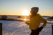 © Westend61 - Mature woman wearing knit hat running during winter