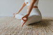 © Westend61 - Female fitness instructor meditating on carpet at yoga studio