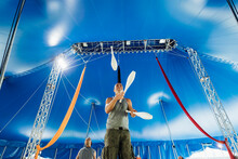 Male Athlete With Juggling Pins Practicing At Circus
