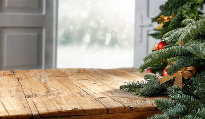 Wall Mural - wooden table with blank, open window and moody christmas background