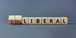 © Dzmitry - Illiberal or liberal symbol. Turned wooden cubes and changed the word illiberal to liberal. Beautiful grey background. Business, political and illiberal or liberal concept. Copy space.