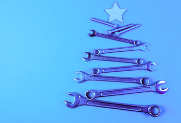 Wall Mural - Christmas tree made of tools for Christmas. Blue background with Christmas tree